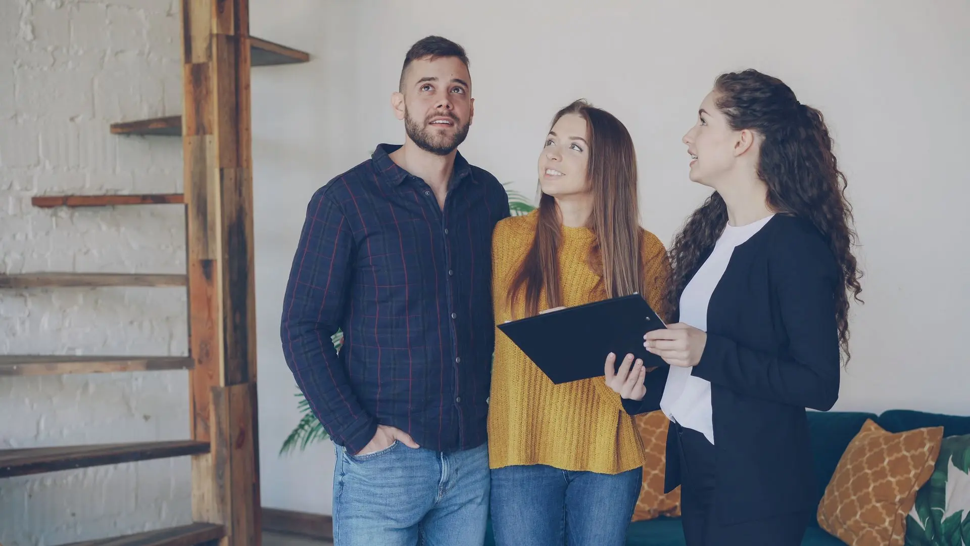 An estate agent showing a property to a young couple